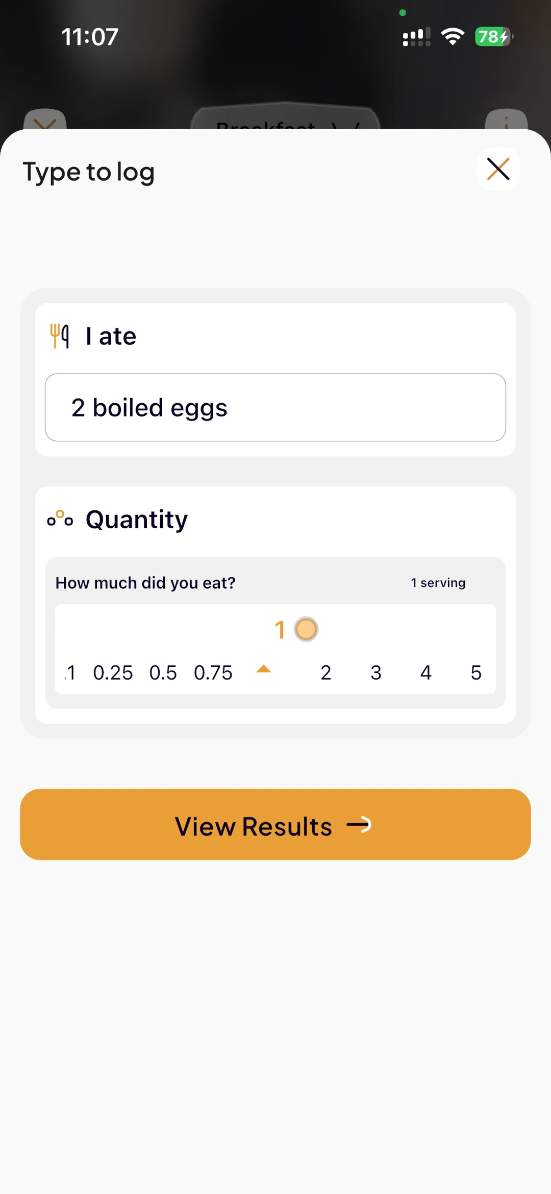 Typing “2 boiled eggs” into SlimAI with a serving-size slider before viewing results